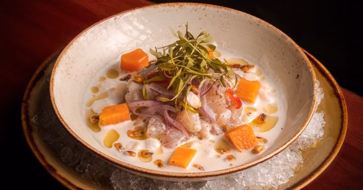 Ceviche with raw fish, red onion, sweet potato, microgreens, and corn in a citrus sauce, served on ice at Rosa Negra.