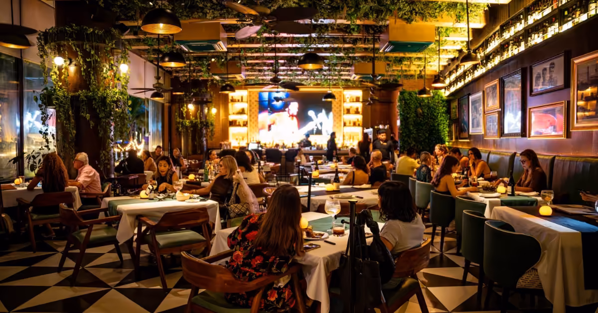 Elegant Argentine restaurant with diners, hanging greenery, cozy lights, and a glowing bar create a warm, welcoming vibe.